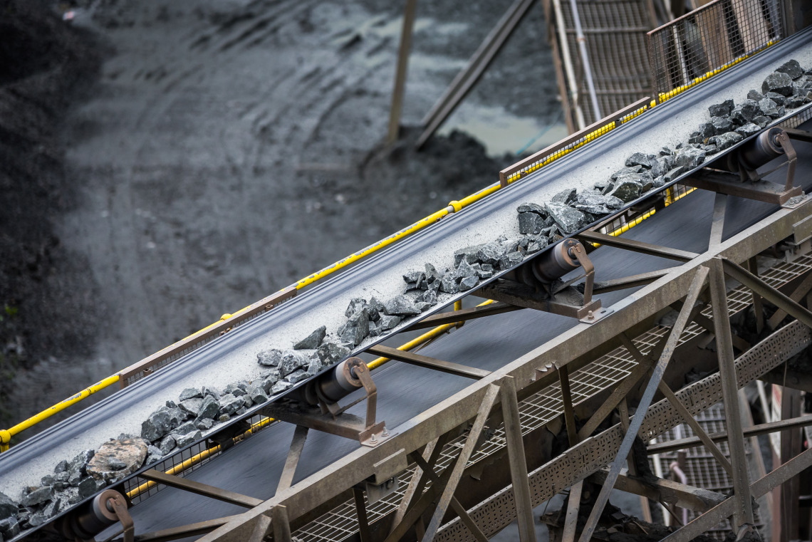 Raw materials from a mine being processed on a conveyor belt