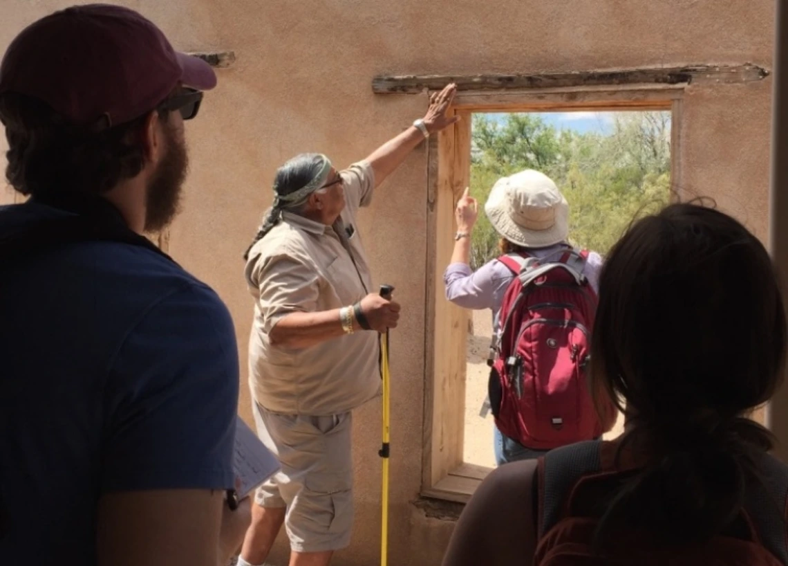 People examining a historical structure