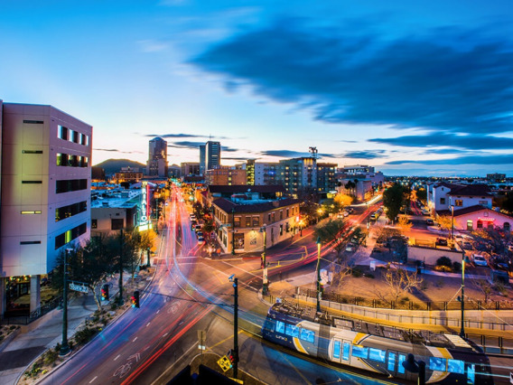 Long exposed image showcasing headlights traveling through downtown Tucson, Arizona in the early evening