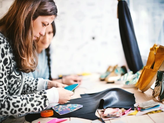 Two students working on a clothing design together