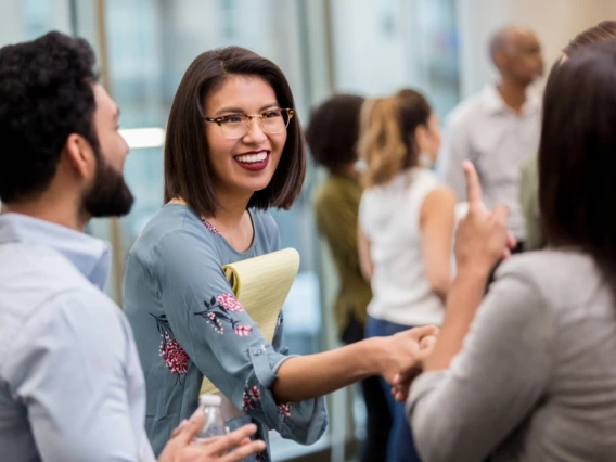 A woman shaking hands and networking with others