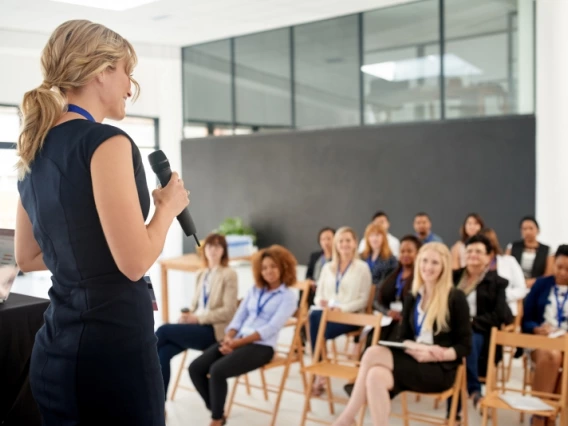 Woman speaking to a business crowd
