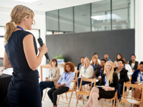 Woman speaking to a business crowd