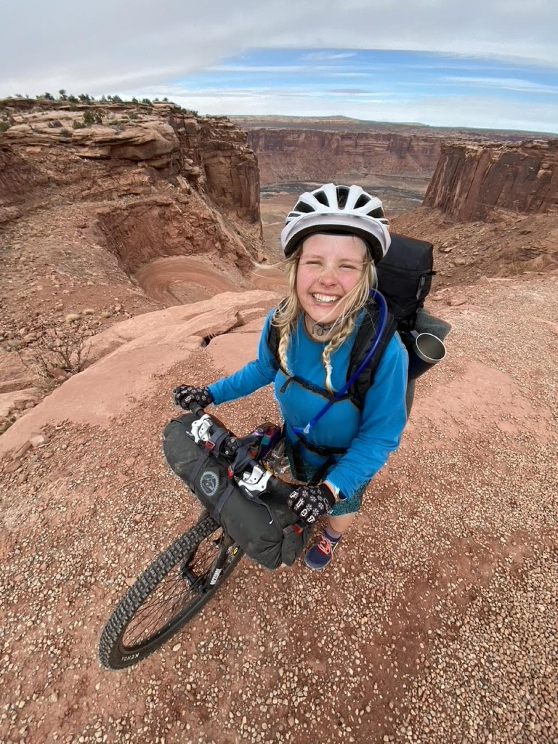 Franny Slater riding a bike in the desert