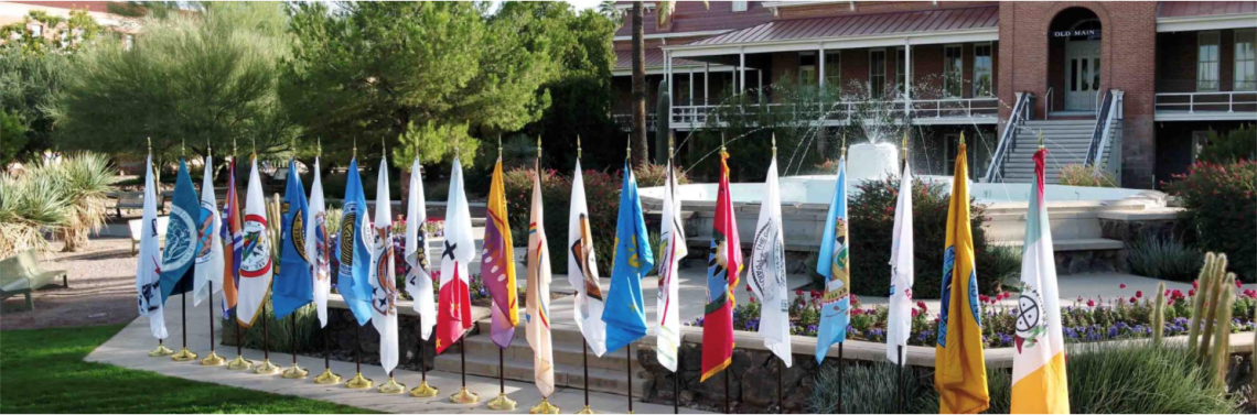 Flags from Tribal Nations being displayed in front of Old Main on the UA campus